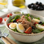Salade protéinée aux œufs durs et thon avec tomates cerises, roquette et vinaigrette moutardée